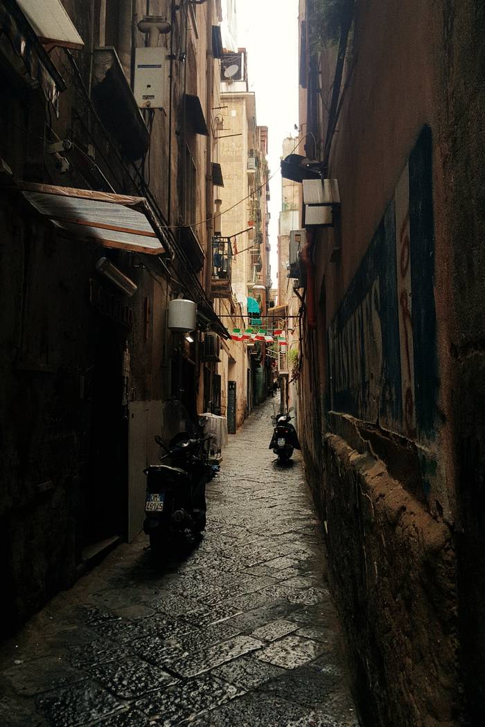 The narrow streets lined with tall apartment complexes found throughout Naples